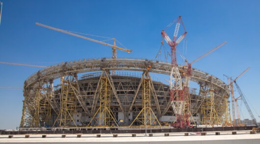 construction-side-of-a-football-stadium-with-cranes-and-scaffoldings