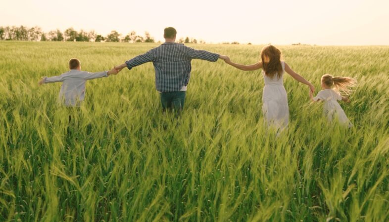 happy-family-with-child-runs-through-wheat-field-holding-hands-slow-motion-mom-dad-and-children-are-walking-together-cheerful-mother-father-and-little-daughter-play-enjoy-nature-outdoors-dream